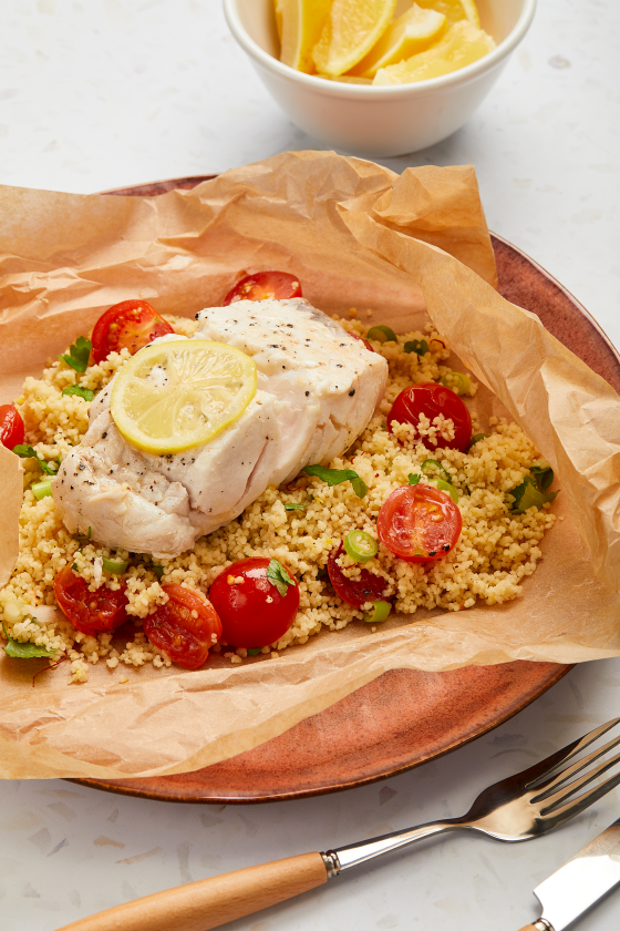 A photograph of Steamed hake with couscous